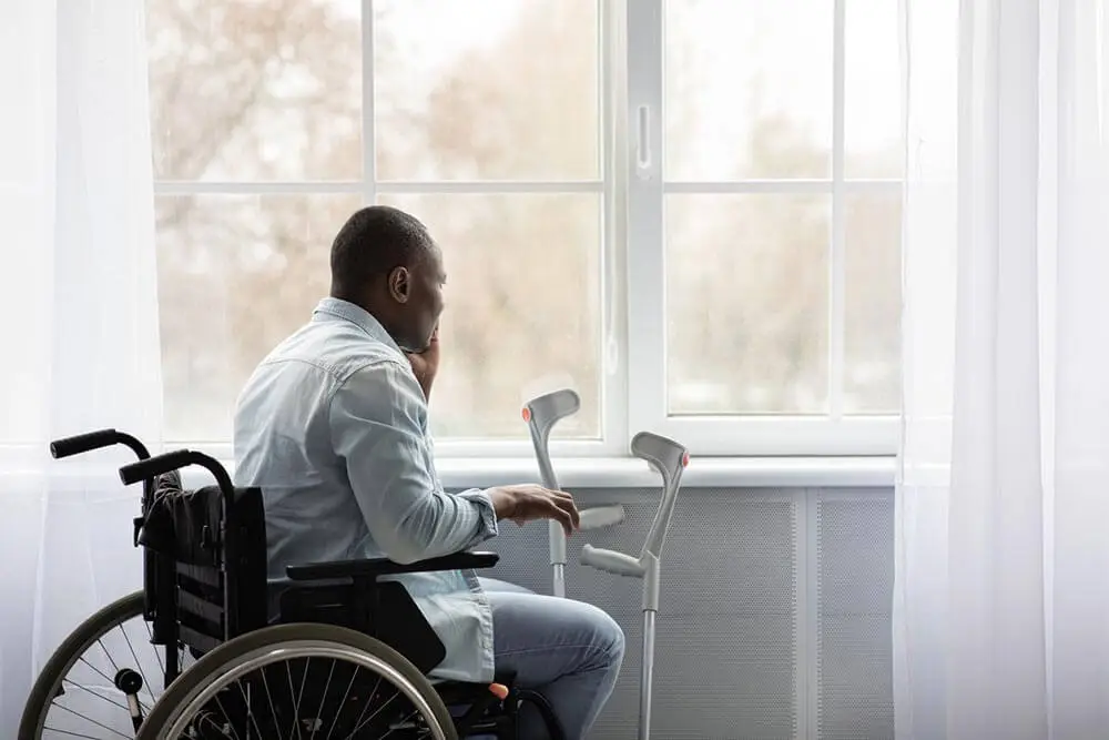 a person in a wheelchair looking at the window