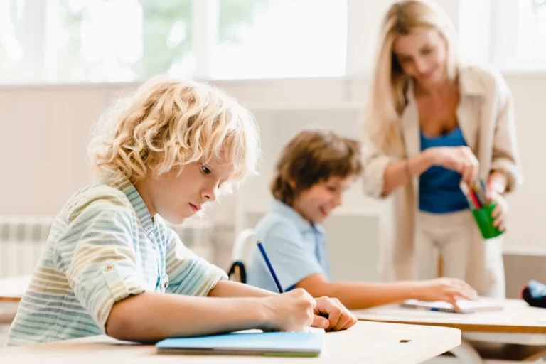 kids on desks writing