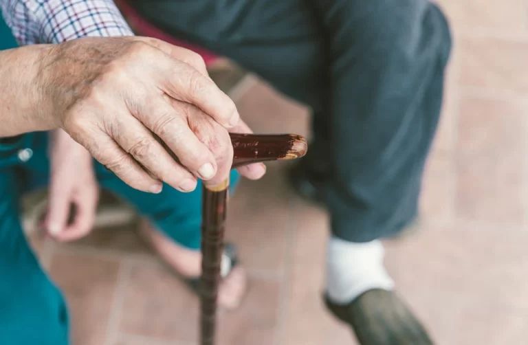 old hands holding a cane