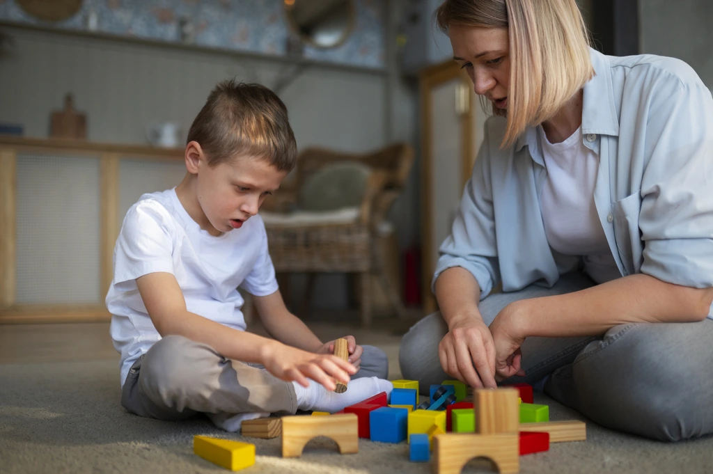 a kid playing with wooden blocks