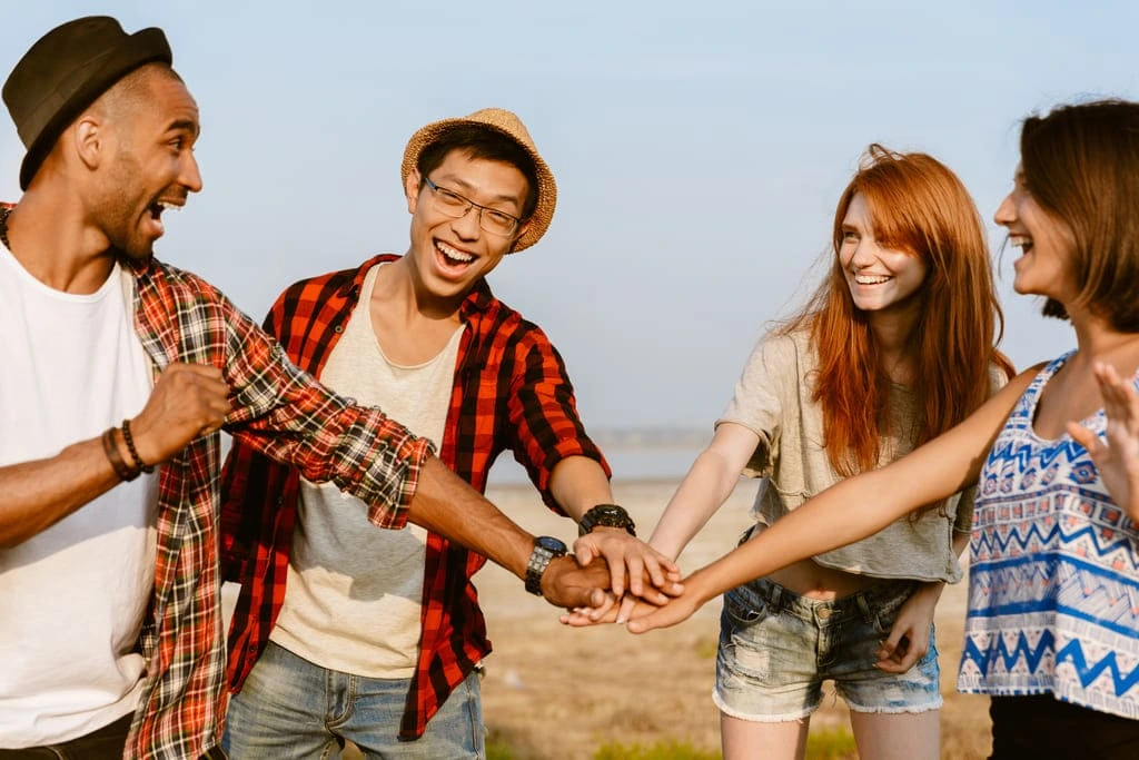 young multiracial friends holding hands