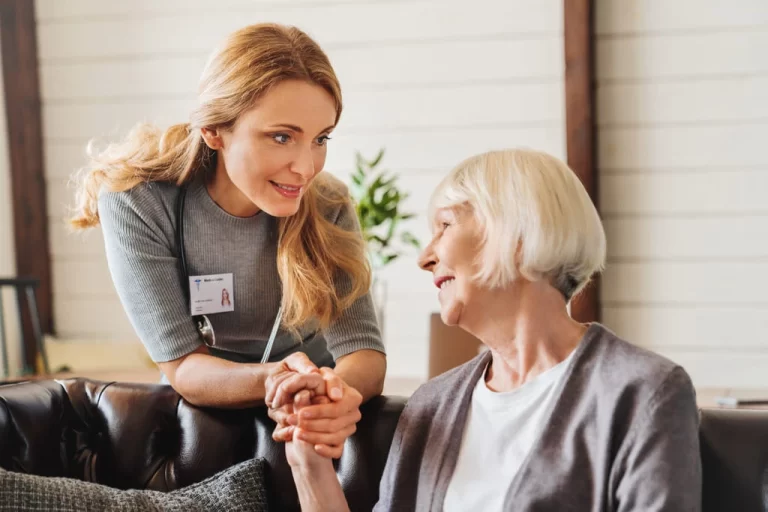 woman support worker hold hand of an elderly lady