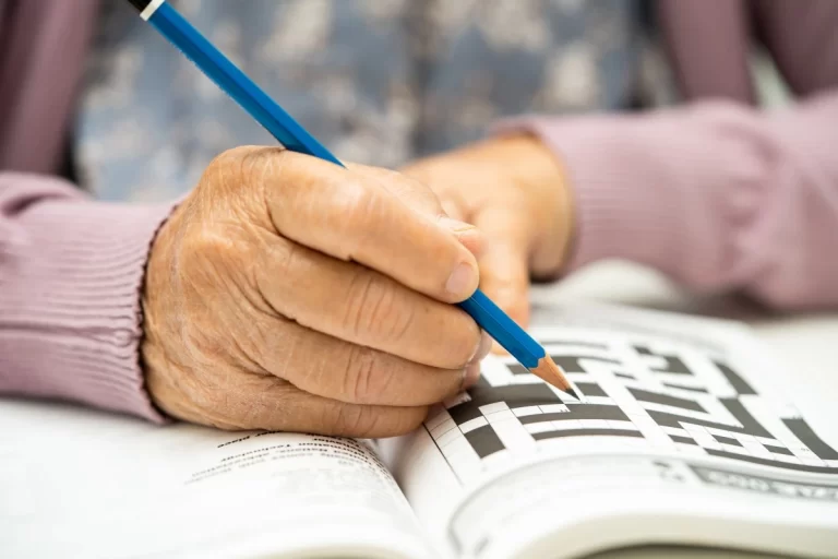 picture of a hand doing crosswords