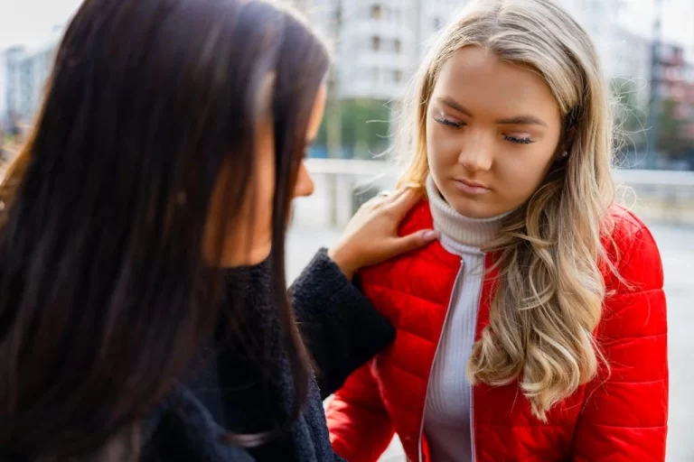 autistic girl being comforted by her friend