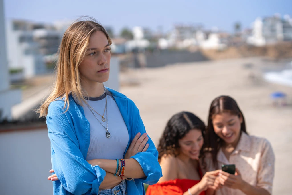 woman using selective mutism while her friends laugh in the background
