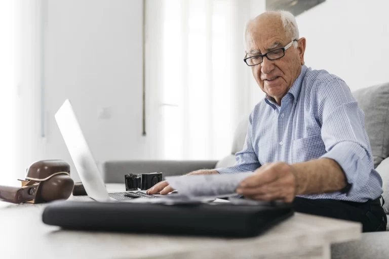 an elderly man looking at some documents
