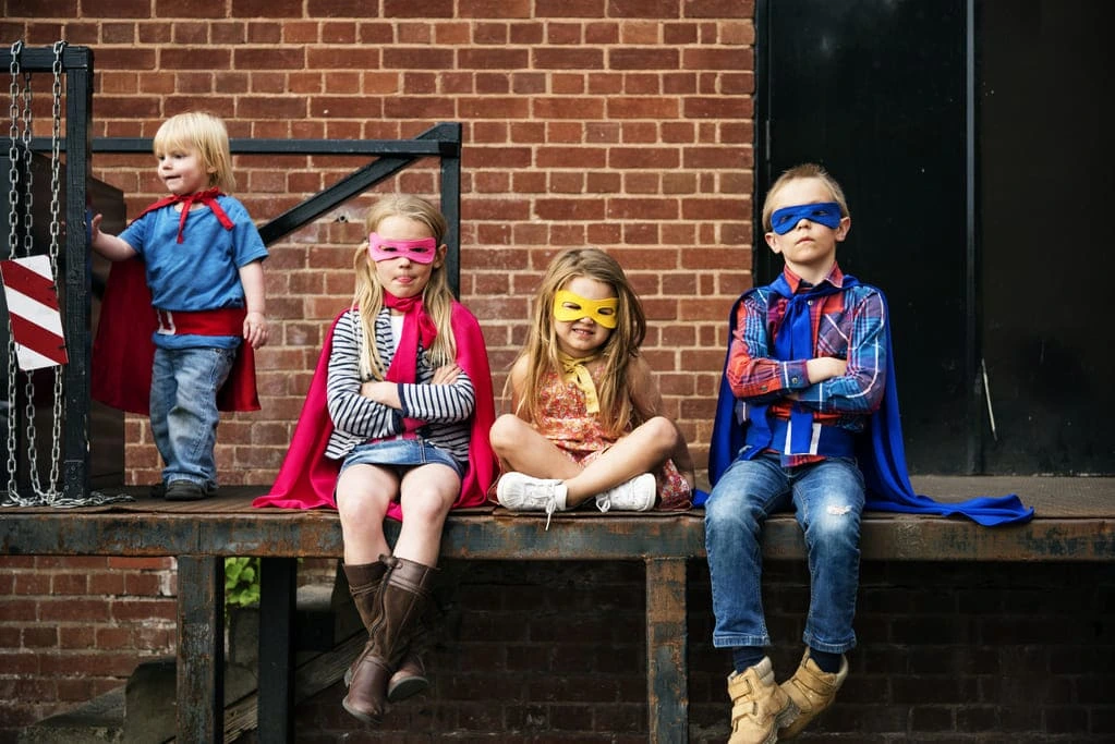 autistic kids posing in superhero costumes