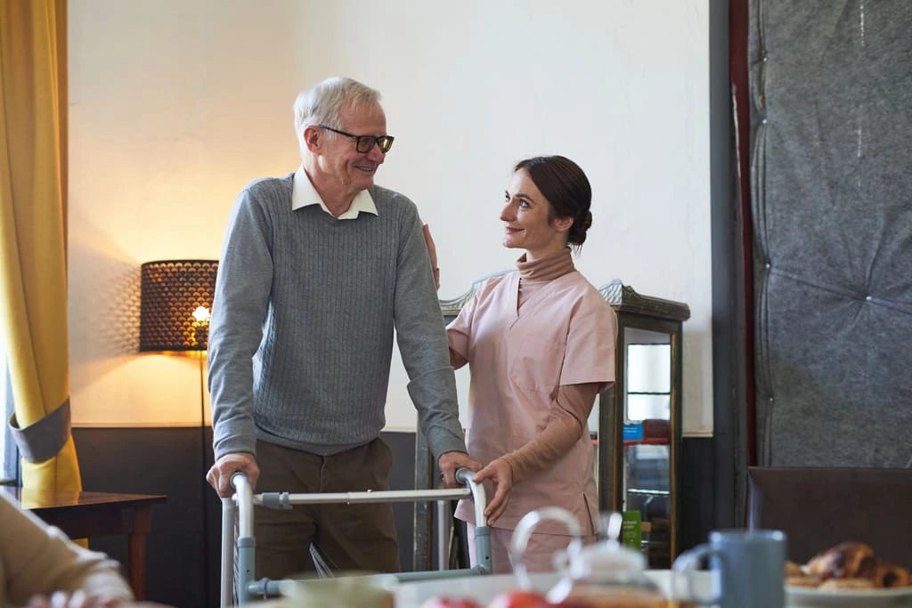 live-in carer helping older man