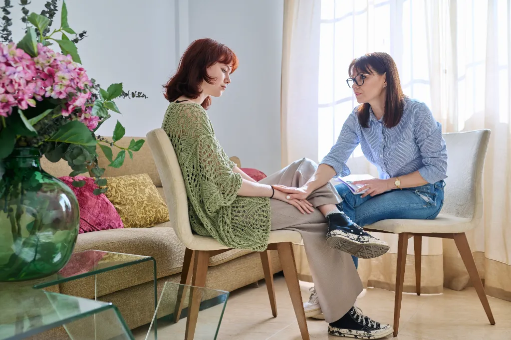 young girl being comforted by her therapist