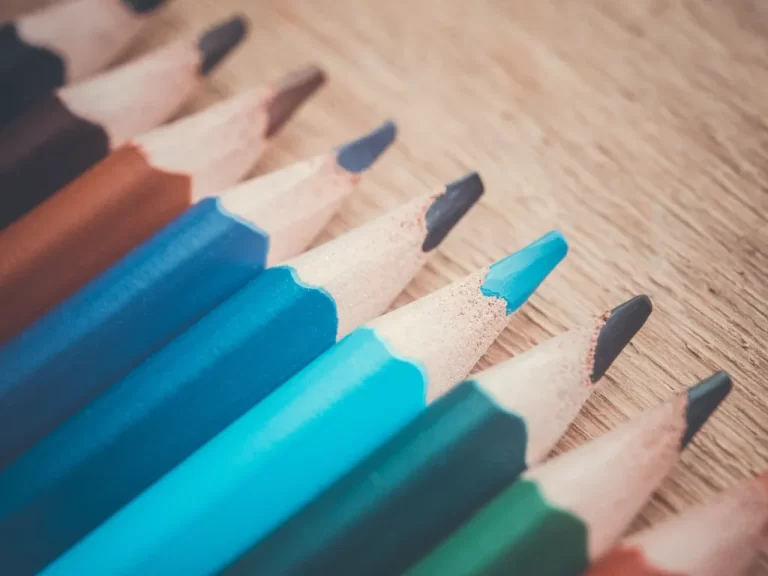 pencils lined up together in a line by colour