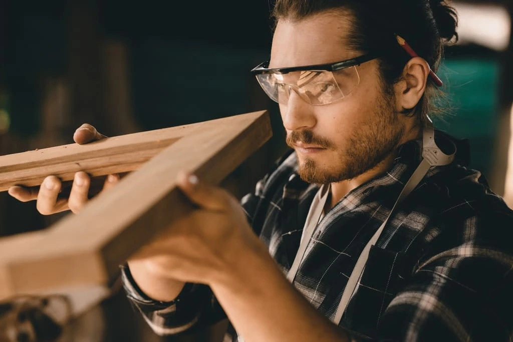 a carpenter with ocd looking at a wooden frame