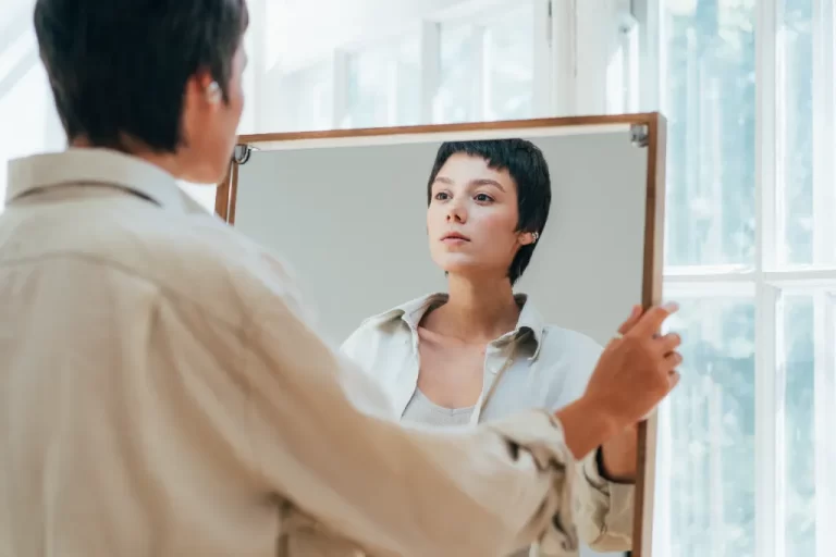 a lady looking at herself in a mirror