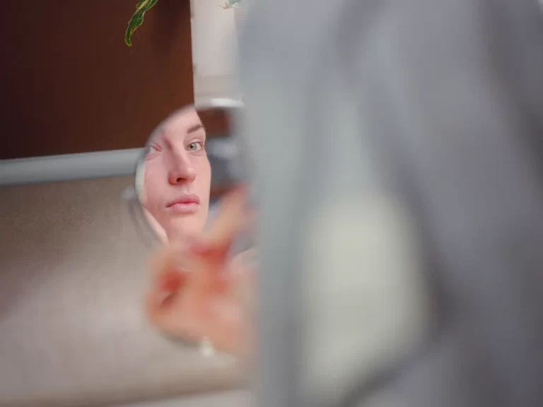 reflection of a woman's face on a small mirror