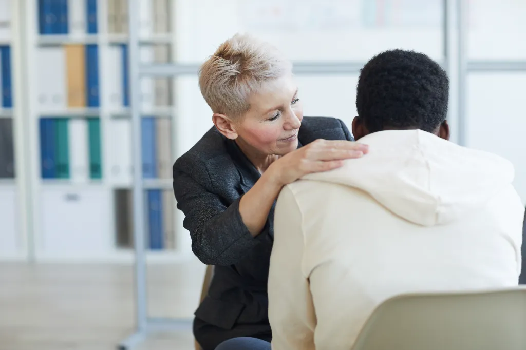 caregiver lady comforting a man with BPD