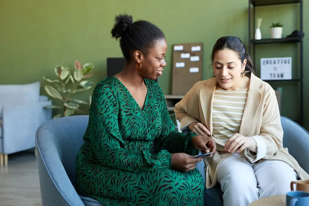 social worker sitting with a lady on a couch