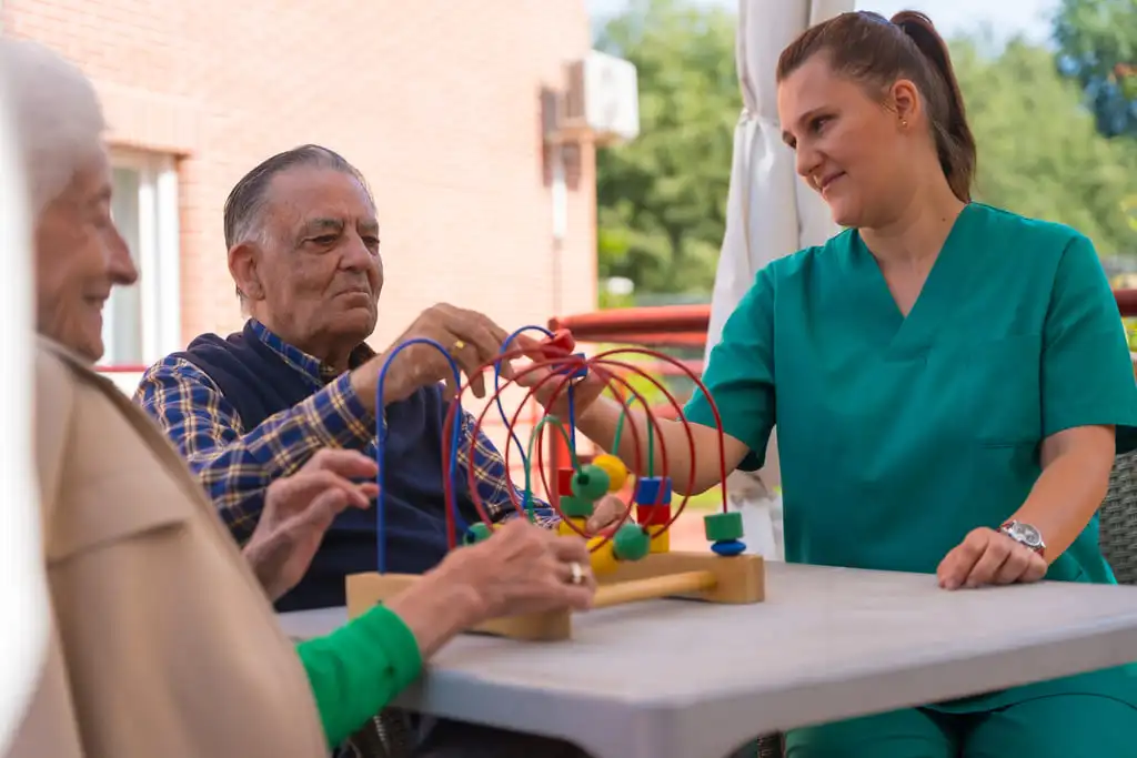 occupational therapist with two elderly patients