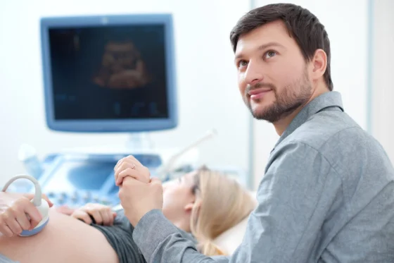a doctor doing a screen test to a pregnant woman