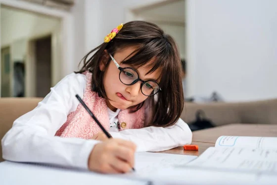 young girl writing in a notebook
