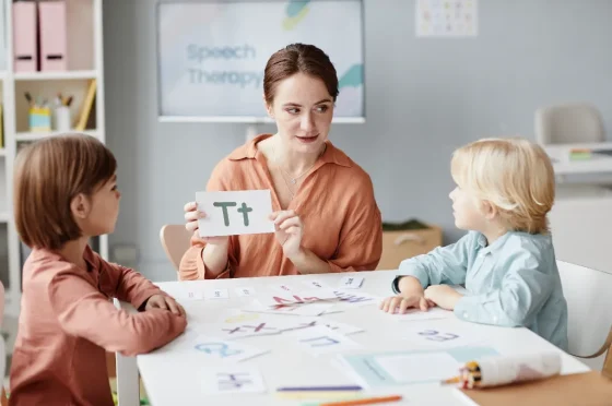 speech and language therapist working with two children