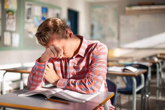 girl sitting in class struggling with academics