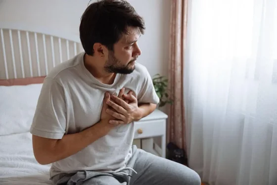 a man sitting in bed before getting a seizure