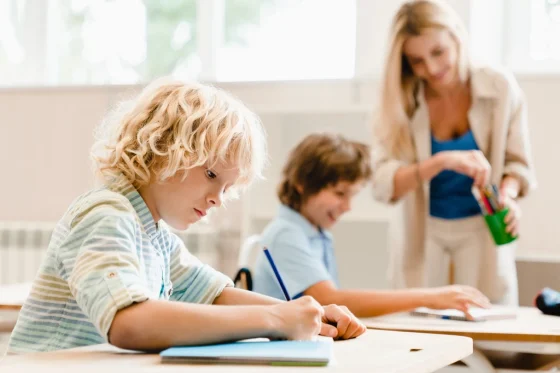 kids on desks writing
