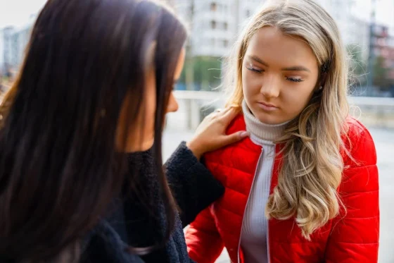 autistic girl being comforted by her friend