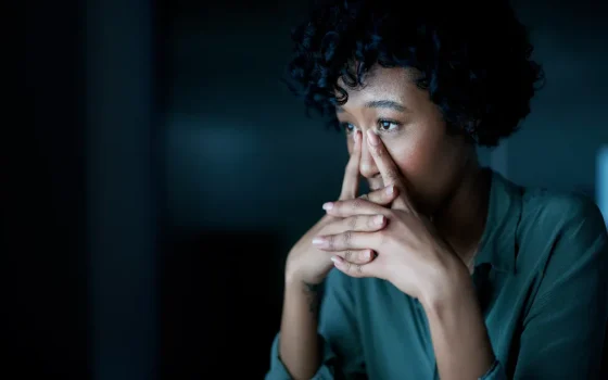 a kid in distress covering her face