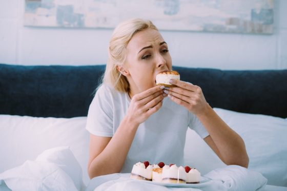 a girl eating a piece of cake