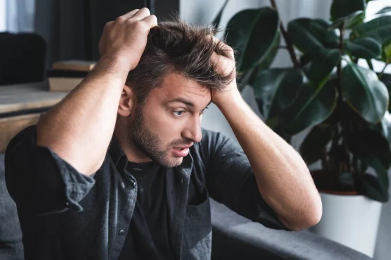 a man holding his head