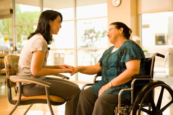 female caregiver talking to a lady in a wheelchair