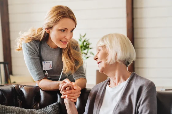 woman support worker hold hand of an elderly lady