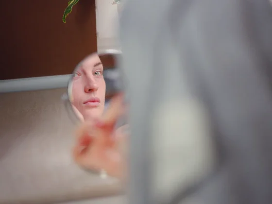 reflection of a woman's face on a small mirror