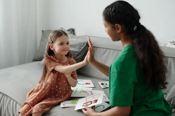 speech and language therapist working with a little girl